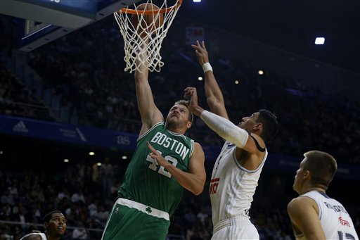 Celtics forward David Lee, left, dunks the ball past Real Madrid's Gustavo Ayon on Thursday at the Barclaycard Centre sport arena in Madrid. The Associated Press