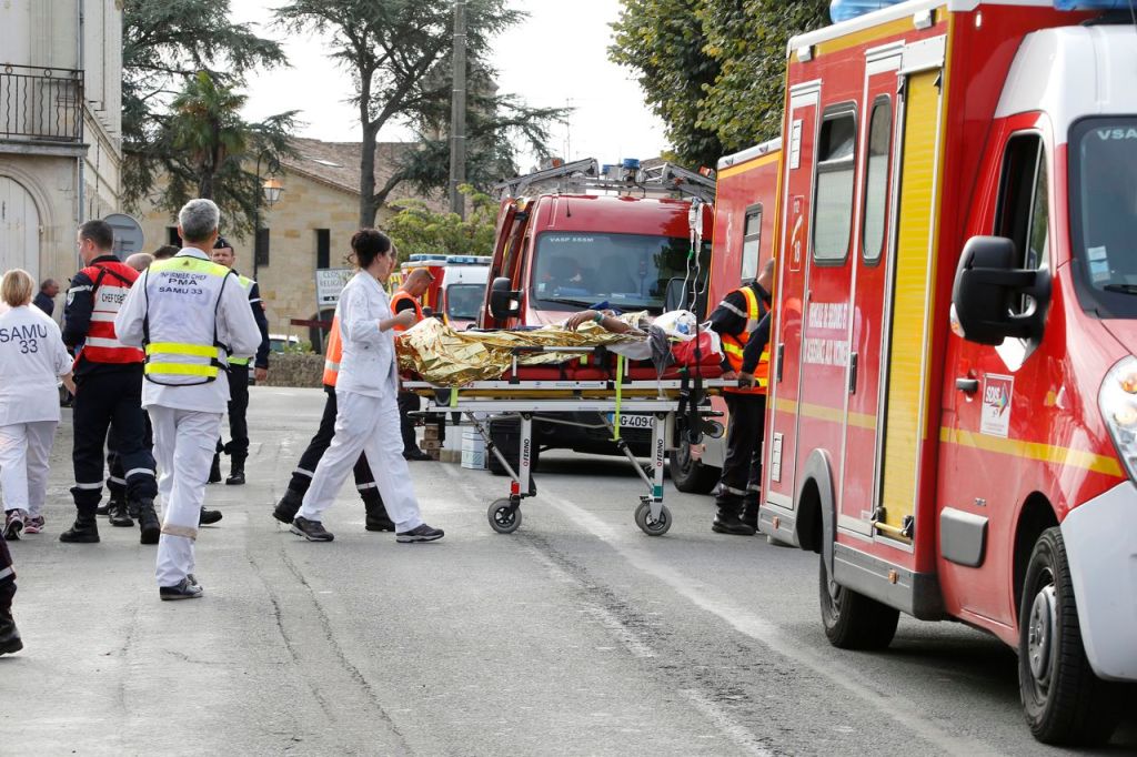 Rescue workers carry an injured person on a stretcher during rescue operations near the site where a tour bus carrying retirees collided with a truck outside Puisseguin near Bordeaux, western France Friday. Reuters