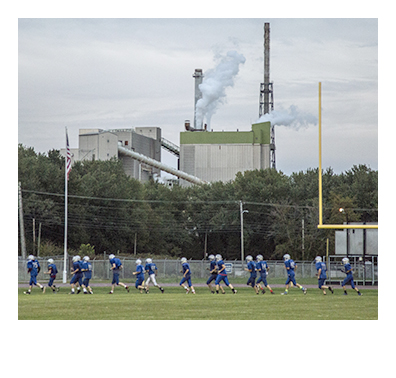 RUMFORD, ME - OCTOBER 1: The Mountain Valley High School football team runs around the perimeter of Hosmer Field before practice, with the paper mill in the background in Rumford, ME on Thursday, October 1, 2015. (Photo by Whitney Hayward/Staff Photographer)