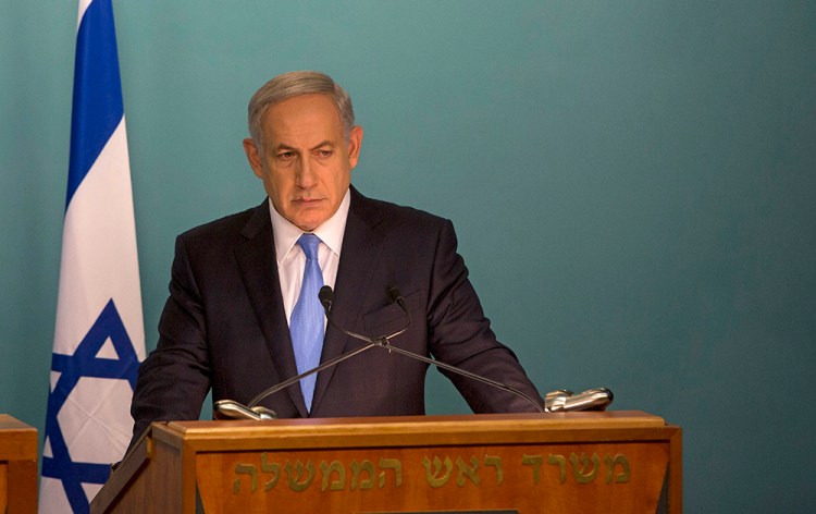 Israeli Prime Minister Benjamin Netanyahu addresses the news media with United Nations Secretary-General Ban Ki-moon at the prime minister’s office in Jerusalem on Tuesday. Netanyahu's Holocaust comments come at a sensitive time, as he is scheduled to travel to Berlin today to meet German Chancellor Angela Merkel. The Associated Press