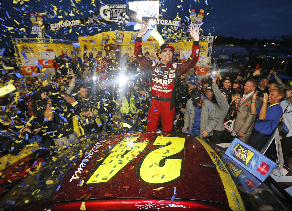 Jeff Gordon celebrates after winning the NASCAR Sprint Cup Series auto race Sunday at Martinsville Speedway in Martinsville, Va.