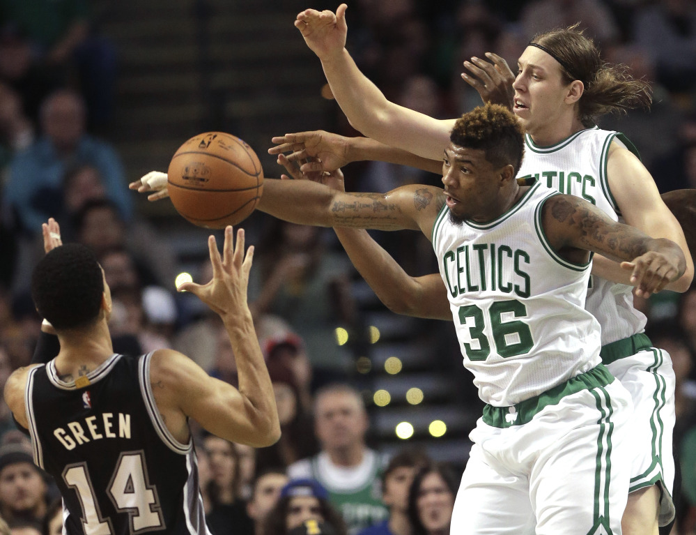 San Antonio guard Danny Green, left, battles for control of the ball with Boston guard Marcus Smart, center, and center Kelly Olynyk, right, in the second quarter Sunday in Boston.