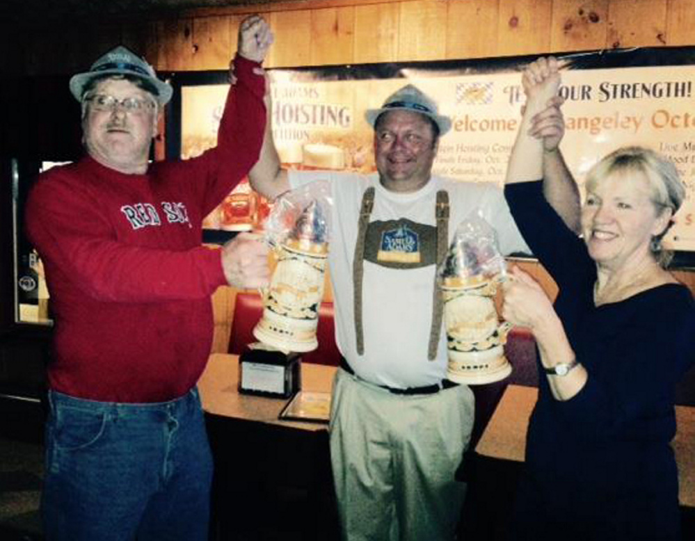 Mickey Bechard, center, with stein winners, Rusty Shorey, men’s category, left, and Sue Lind, women’s category, right.