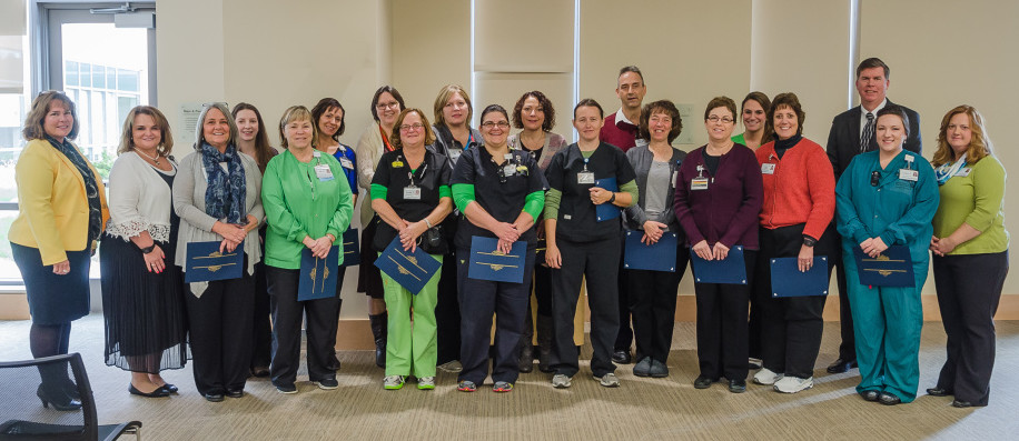 Flanking the nurses who earned certificates in front line leadership are, at left, Commissioner Jeanne Paquette of the Maine Department of Labor and Jennifer Riggs, chief nursing officer at MaineGeneral. At right is Jennifer Boynton,  coordinator, Staffing & Resource Management at MaineGeneral, and third from right in back, Chuck Hays, CEO, MaineGeneral Health.
Nurses who earned apprenticeship certificates, beginning third from left, are Kathleen Clark, Amy Adams, Janice Tillson, Tina Stubbert Roy, Margaret Almand, Ellen Treadwell, Elizabeth Doyen, Mary Rogers, Sherry Collins, Naomi Miller, Rick Haase, MaryAnn Constanzer, Susan McDonald, Karen Takatsu, Lisa Snow-Manelick, Janet Peacock.