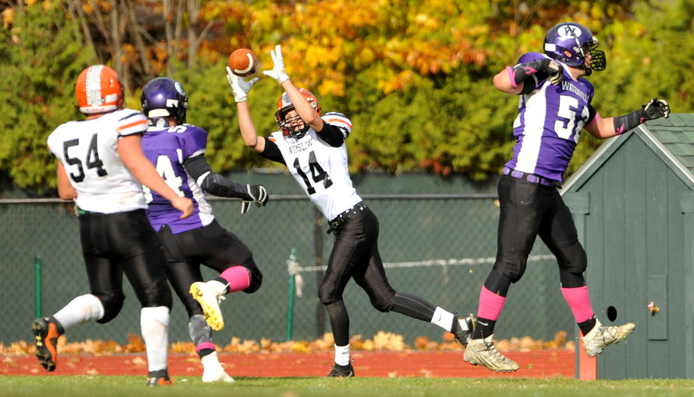 Winslow’s Dylan Hutchinson (14) hauls in a two-point conversion pass during the regular season finale with Waterville last month. The Raiders return to action this Saturday against MDI in a Big Ten Conference semifinal.