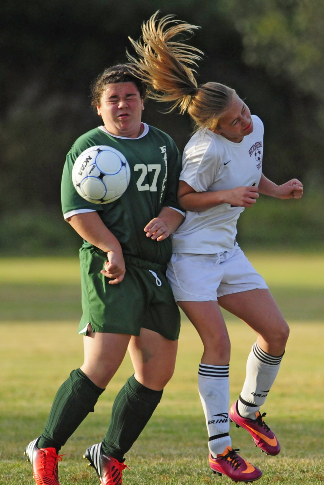 Rangeley’s Mary Page Swiney, left, and Richmond’s Jade Gammon collide during a Western D playoff game last season in Richmond. The teams meet again at 2 p.m., today in the Class D South regional final.