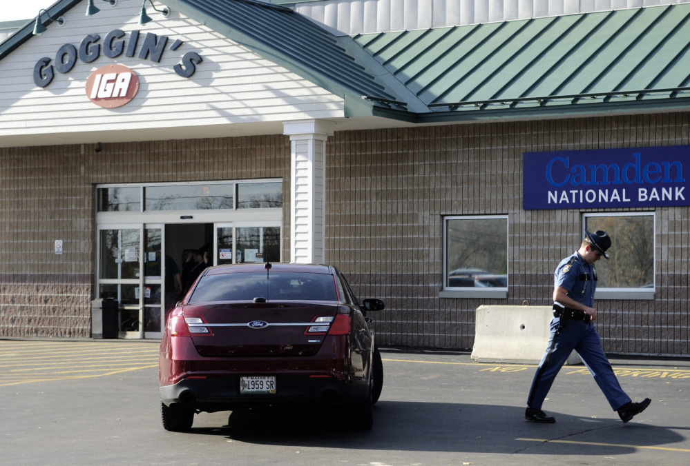 Police investigate the Saturday robbery at the Camden National Bank in Goggins IGA in Randolph.