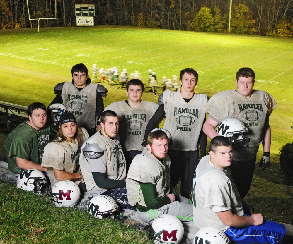 Winthrop/Monmouth offensive linemen pose for a photo on Tuesday at Maxwell Field in Winthrop. They are from left to right front row: Ryan Hafford, Jack Vickerson, Brendon Dunn, Josh Ward, Luke St. Hilaire; bottom row: Zach Wallace, Jared Gosselin, Ben Ames and Hunter Hamlin.