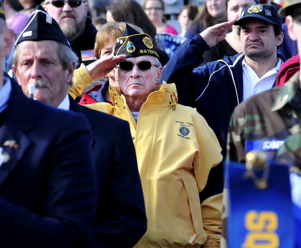 Veteran Reginald Joler salutes during a Veterans Day ceremony in Waterville on Nov. 11, 2014.