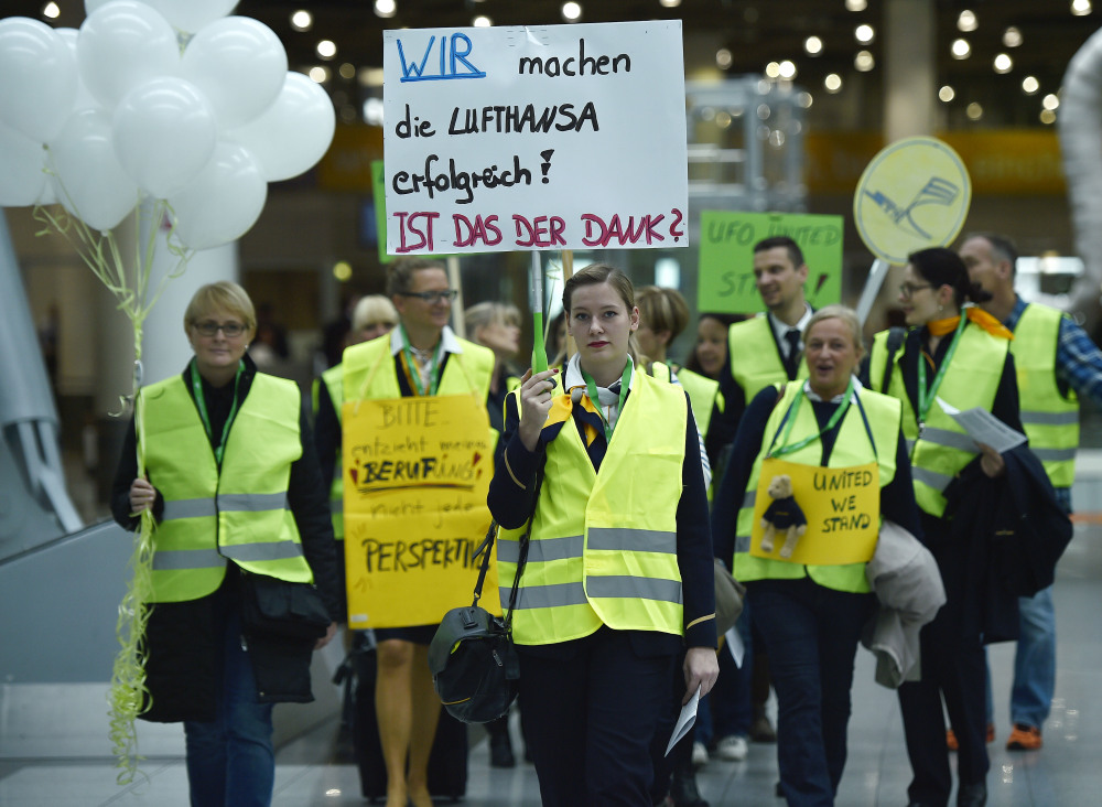 The Associated Press Lufthansa flight attendants protest at the airport in Duesseldorf, Germany, on Friday. The poster reads “we make Lufthansa successful – is this the gratitude?”