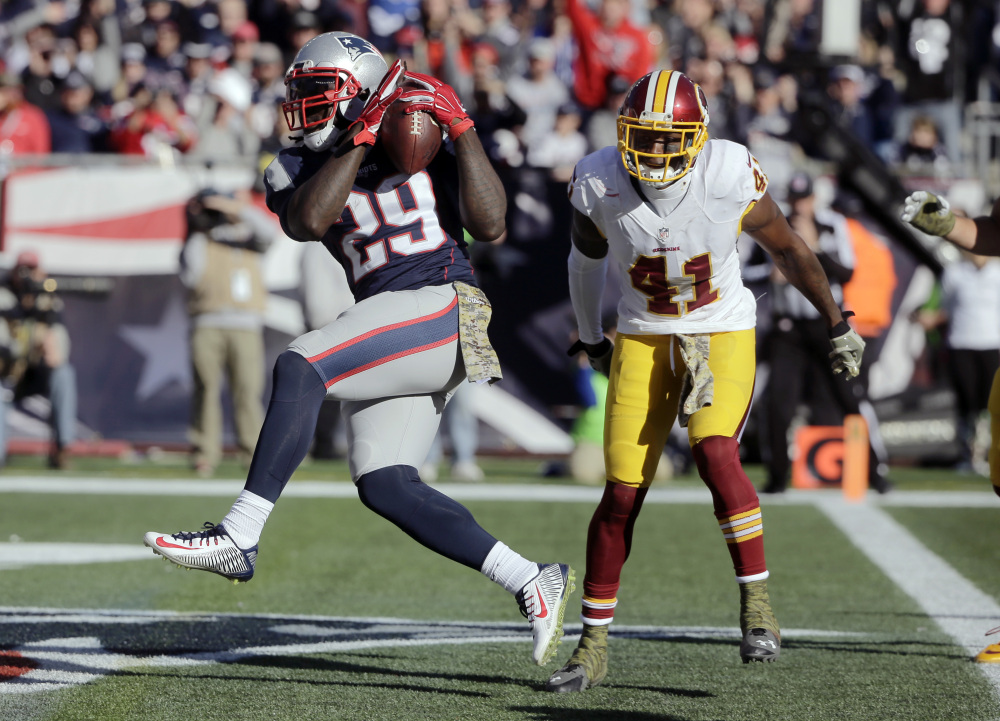 Patriots running back LeGarrette Blount crosses the goal for a first-half touchdown in front of Washington cornerback Will Blackmon on Sunday in Foxborough, Massachusetts.