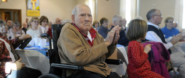 World War II veteran Les Hann applauds on Sunday a fellow veteran during a panel presentation at Penney Memorial United Baptist Church in Augusta.
