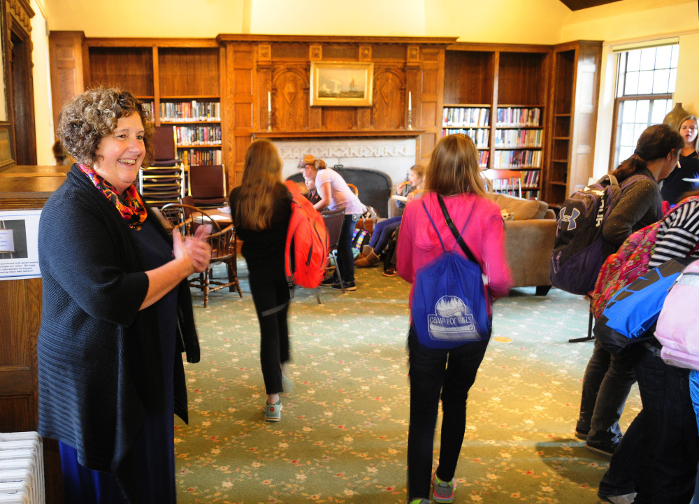 Library Director Anne Davis greets a group of middle school students as they walk into Hazzard Reading Room for a weekly after-school program on Thursday at Gardiner Public Library.