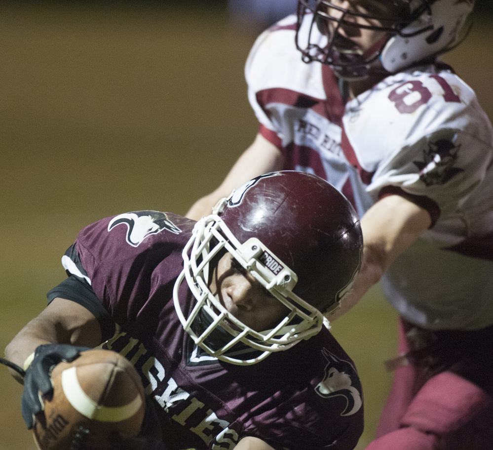 Maine Central Institute’s Willie Moss stretches the ball into the end zone as Orono’s Sam Honey defends last Friday during a Little Ten Conference semifinal Friday night. The top-seeded Huskies (9-0) host No. 2 Mattanawcook (7-2) in the conference final Friday.