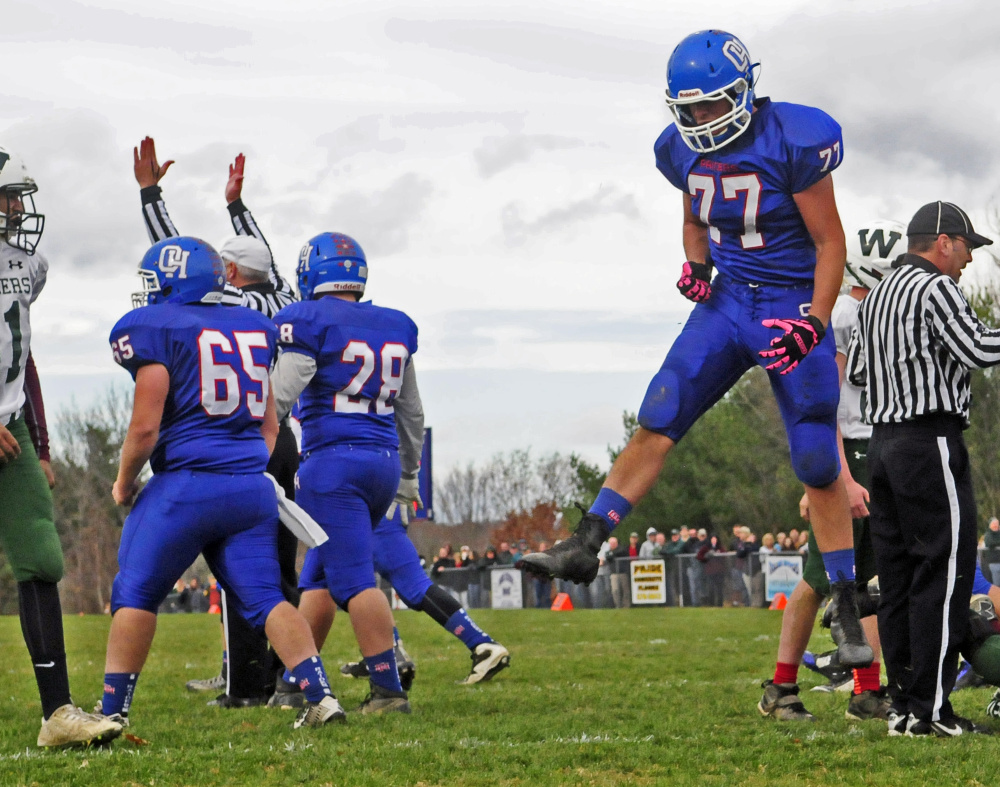 Oak Hill offensive lineman Austin Gaucher leaps for joy after Dalton Therrien scored the Raiders' first touchdown during a Campbell Conference Class D semifinal game Saturday in Wales.
