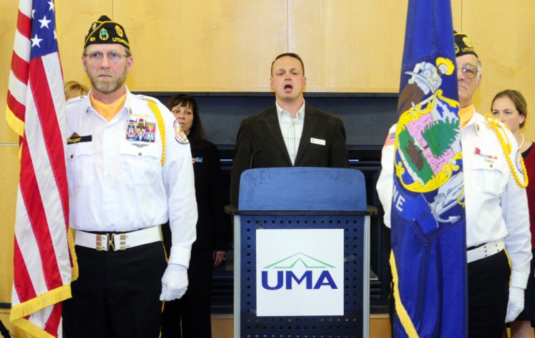 Nathaniel Grace, center, sings the national anthem while flanked by Kennebec County Veterans Honor Guard members Roger Line, left, and Normand Bernier during a veterans’ event Tuesday in the Randall Center at the University of Maine at Augusta.