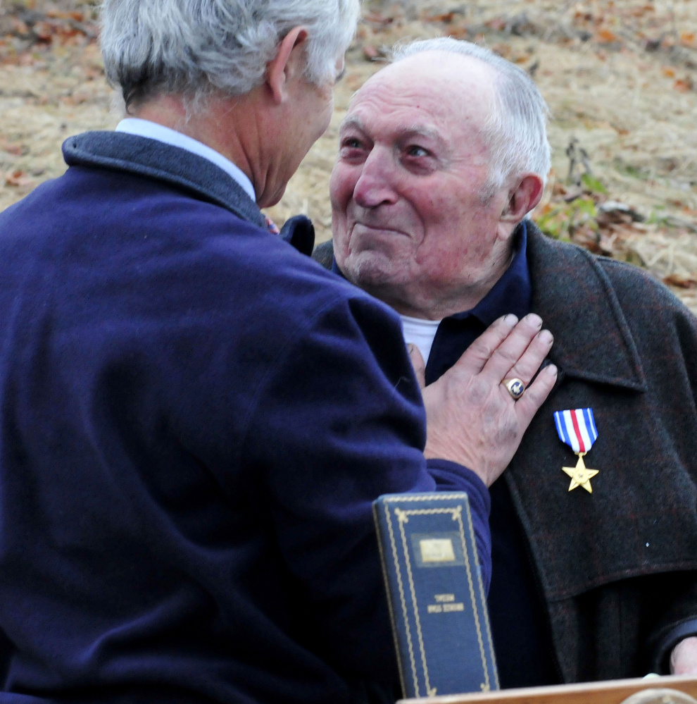 State Sen. Tom Saviello, R-Wilton, left, congratulates Raymond Adams after presenting him with a Silver Star for his duty in World War II at Wednesday’s Veterans Day ceremony in Farmington. Adams earned the medal in the war, but never received it.