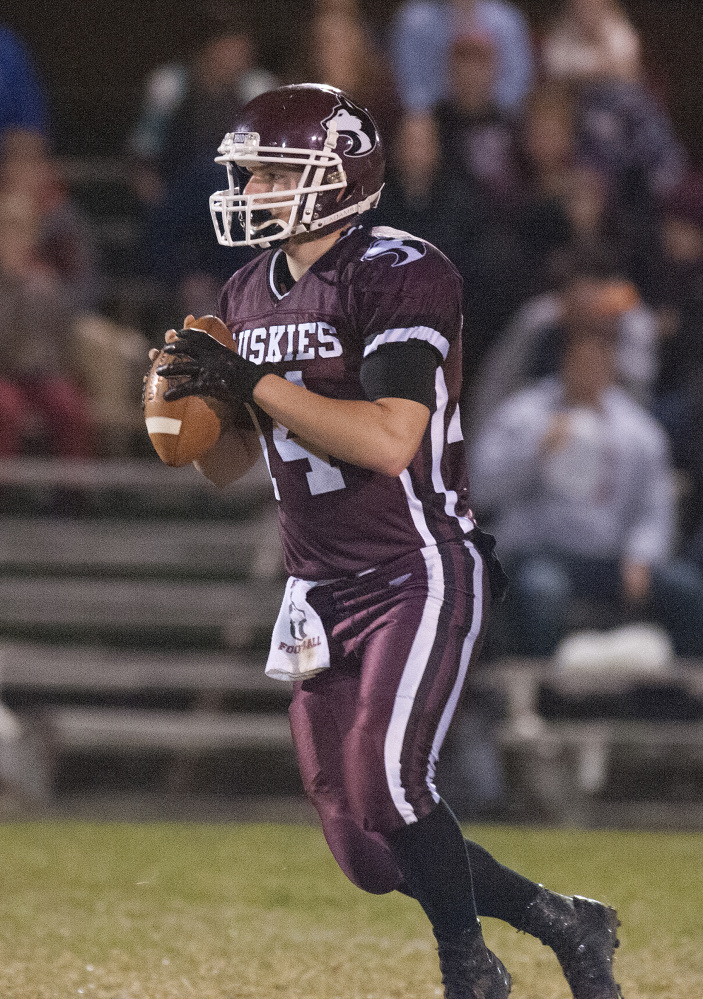 MCI quarterback Greg Vigue looks for a receiver down the field during the Little Ten Conference championship game last Friday night against Orono.