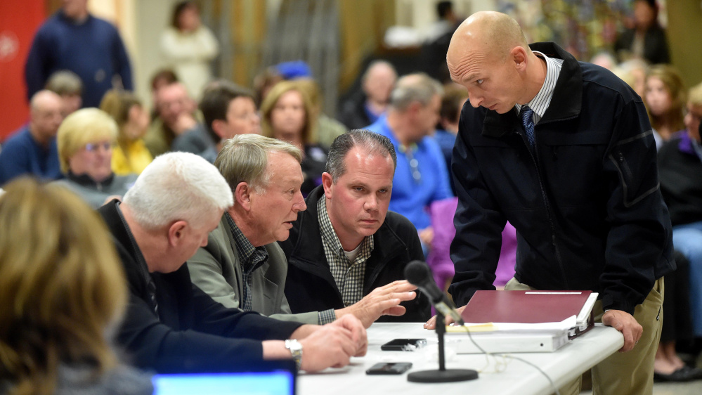 Eric Haley, left center, superintendent of schools, confers with Waterville police detectives Dave Caron, right center, and Bill Bonney, far right, during the public portion Wednesday night of the Waterville Senior High School Principal Don Reiter’s dismissal hearing.