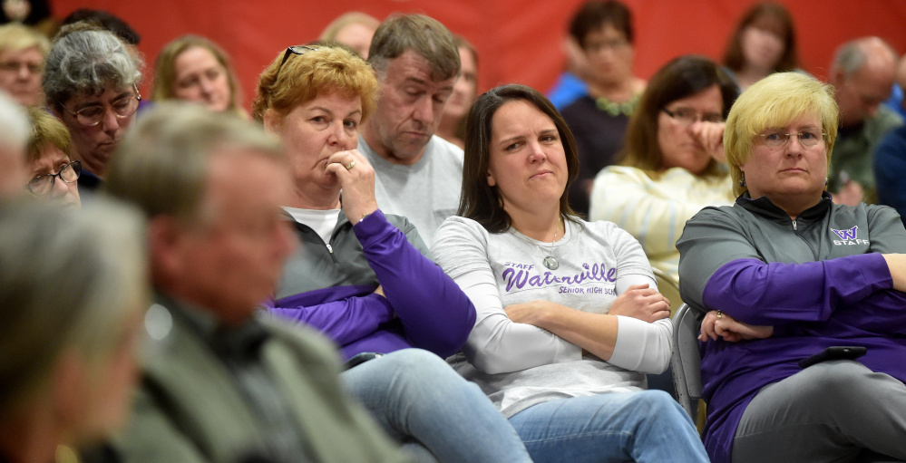 Audience members listen to some of the public testimony Wednesday night at the Board of Education hearing on Waterville Senior High School Principal Don Reiter’s dismissal recommendation. Much of the seven-hour hearing was being closed doors, angering many who attended.