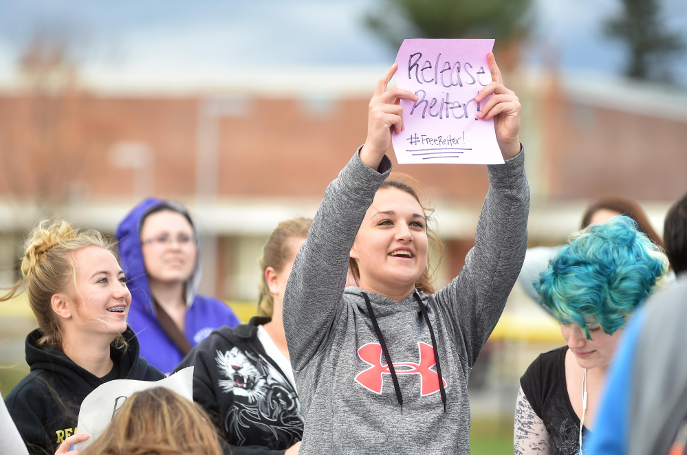 Amber Hill, 16, a junior at Waterville Senior High School, holds a sign in support of her principal, Don Reiter, at rally at Waterville Senior High School in Waterville on Friday. Reiter, accused of propositioning a student, has been on administrative leave since Sept. 1.