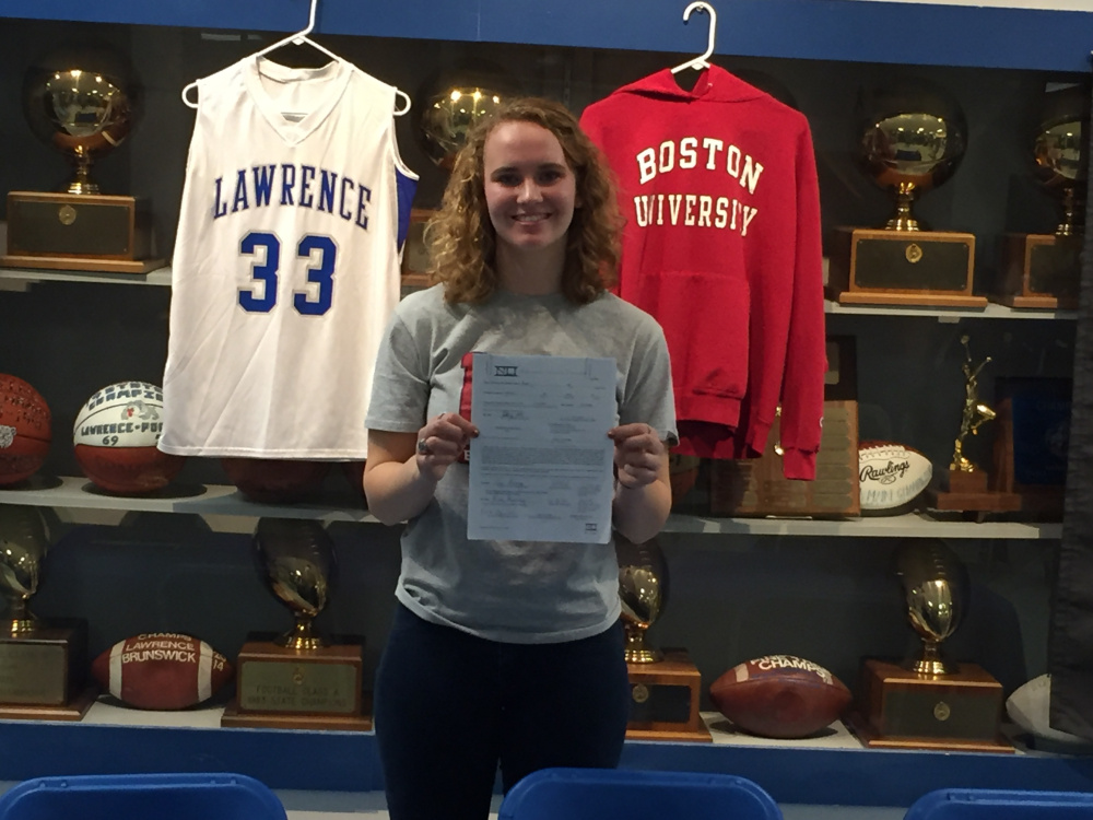 Lawrence senior Nia Irving holds her National Letter of Intent she signed to attend Boston University on Friday night in Fairfield.