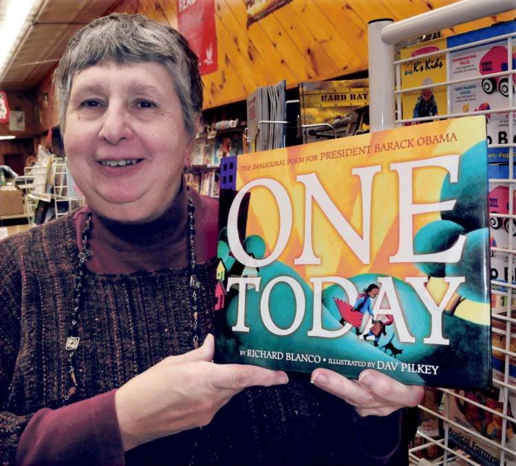Waterville bookstore owner Ellen Richmond holds a copy of “One Today” by Bethel poet Richard Blanco. Richmond, who owns the Children’s Book Cellar, is hosting a reading and signing for Blanco that will be held in the Waterville Opera House Deb. 15.