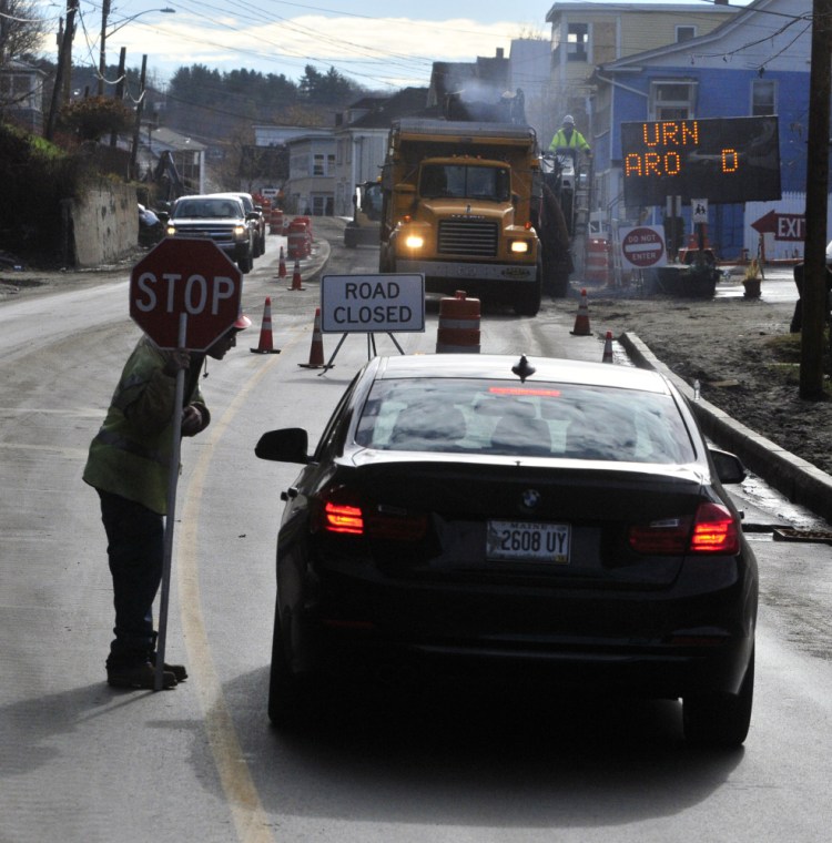 Flagger Devin Pooler explains to a southbound driver on Mount Vernon Avenue in Augusta on Friday that one-way traffic is up ahead and so they must turn around. The road is expected to open to two-way traffic on Friday.