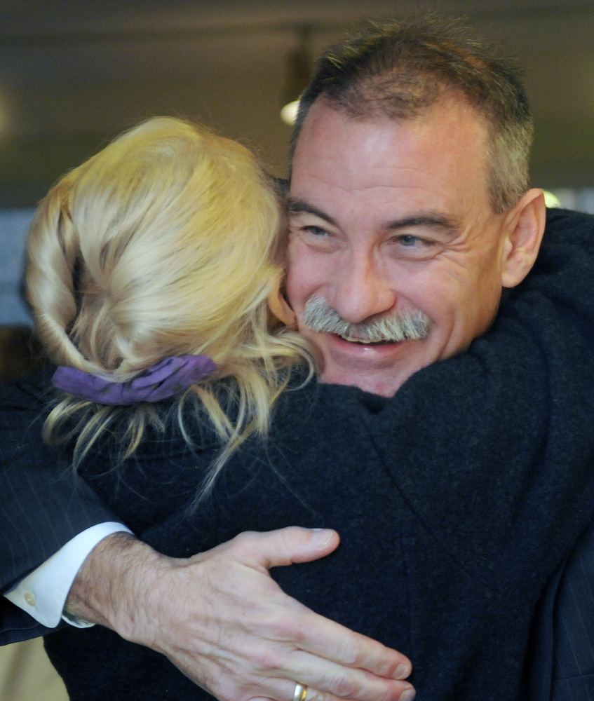 Former Assistant Secretary of State Robert Charles greets a friend on Sunday before giving a talk on international terrorism at the Cary Memorial Library’s Williams House in Wayne.