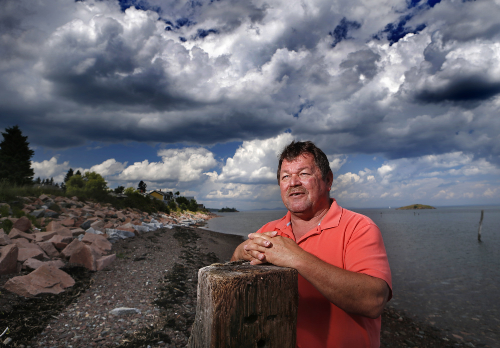 In this July 31 photo, Passamaquoddy tribal Chief Frederick J. Moore poses on the waterfront at Pleasant Point. A century after the state outlawed the salmon spear fishing that fed their ancestors, Native American tribes who trace their history back millennia say their trust in the government of Maine is at an all-time low.