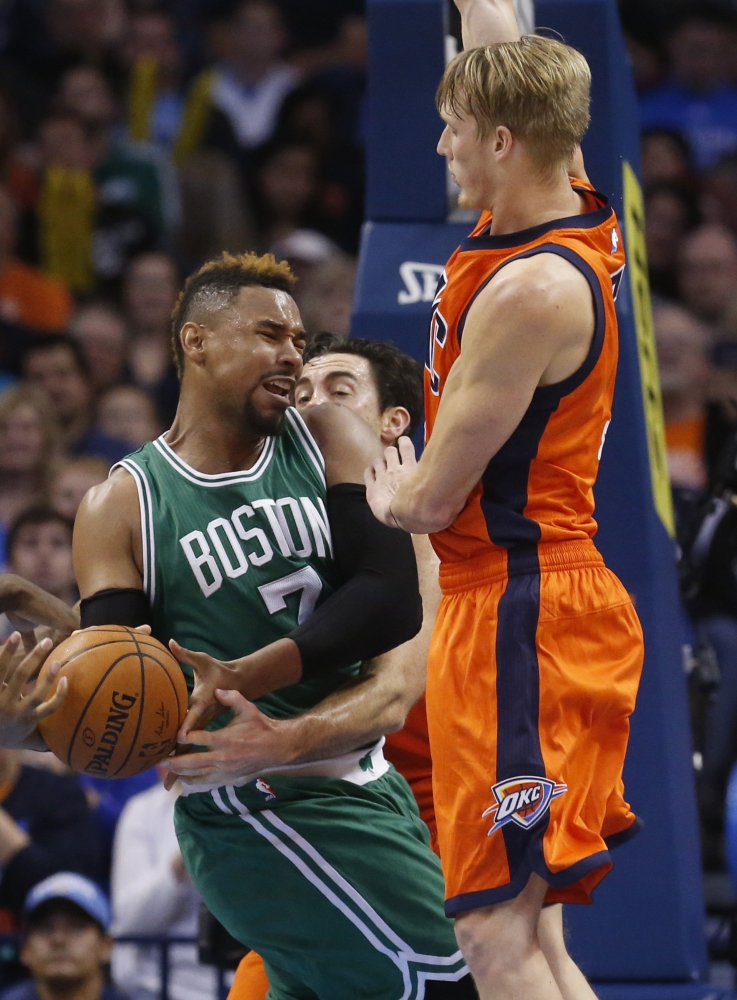 Boston Celtics center Jared Sullinger (7) is fouled by Oklahoma City Thunder forward Nick Collison, center, as Thunder forward Kyle Singler, right, also defends in the second quarter Sunday in Oklahoma City.