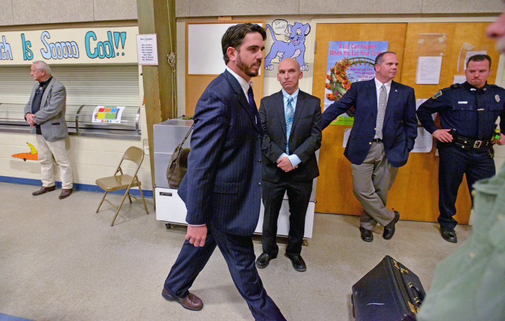 Waterville Senior High School principal, Don Reiter, leaves a public hearing Tuesday at George J. Mitchell School in Waterville. Waterville police Detective Sgt. Bill Bonney, with hands folded, looks on.