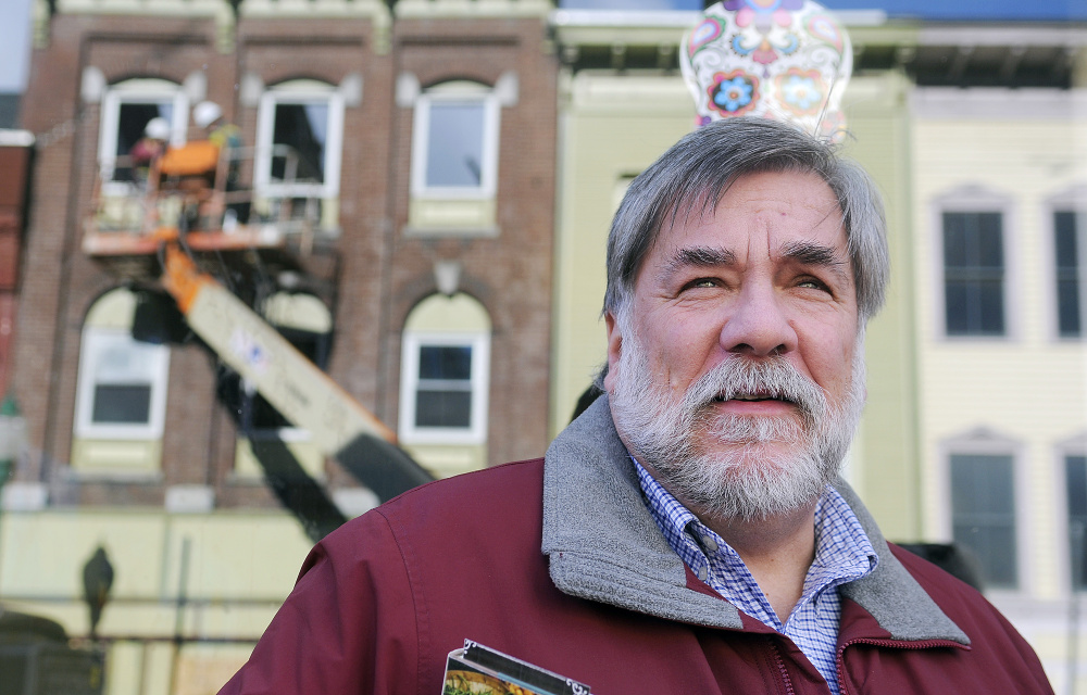 Gardiner Mayor Thom Harnett watches demolition of 235 Water St. commence, four months after a major fire damaged the building.