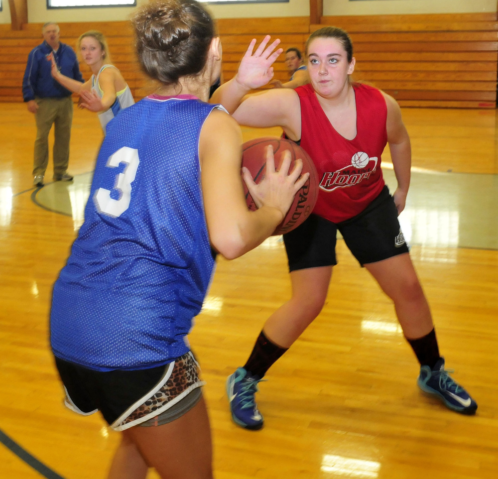 Staff photo by David Leaming
Lawrence players Elise Guimond, left, and Olivia Gray go through drills during practice Monday.