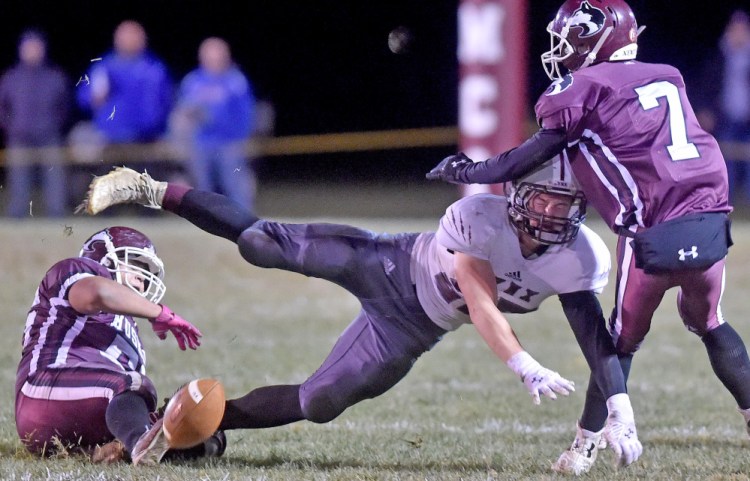 Maine Central Institute defenders Alex Jones, left, and Josh Buker (7) break up a pass intended for Mattanawcook’s Scott Jipson during the Class D North title game Friday night.