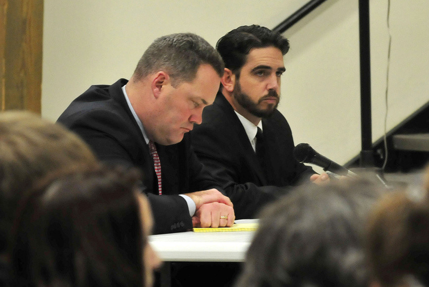 Attorney Gregg Frame, left, and former Waterville Senior High School Principal Don Reiter listen to the proceedings at Monday night’s dismissal hearing.