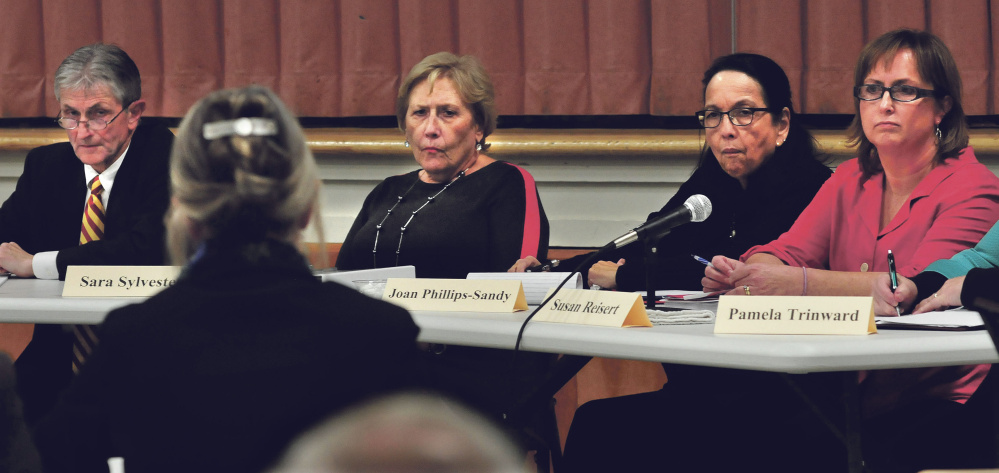 Attorney Bryan Dench, left, and members of the Waterville Board of Education listen to attorney Melissa Hewey speak at Monday’s hearing to dismiss Waterville Senior High School Principal Don Reiter. The board voted 6-1 for dismissal. Next to Dench are, from left, Chairman Sara Sylvester and members Joan Phillips-Sandy and Susan Reisert.