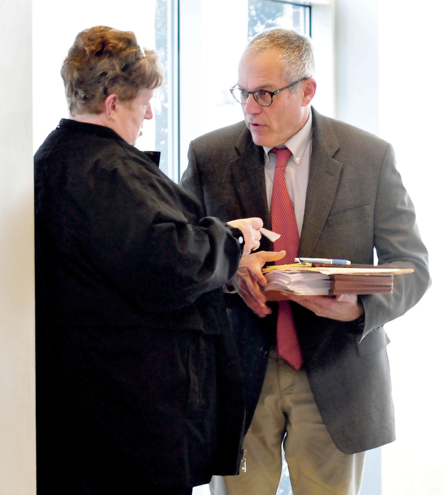 Attorney Walter Hanstein speaks with client and former district attorney office secretary Julie Smith on Wednesday before entering Somerset Superior Court in Skowhegan for a dispositional hearing on charges of embezzling funds and tampering with public records.