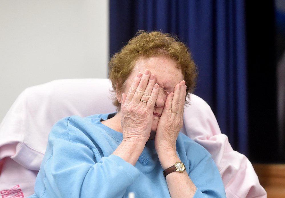 Charlotte Curtis, selectman, wipes her eyes as the open session meeting carries on at the town office in Norridgewock on Wednesday
