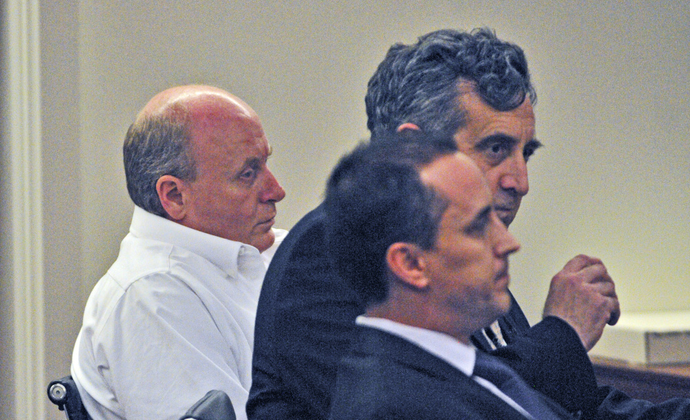Staff photo by Joe Phelan
Roland L. Cummings, left, sits beside his defense attorneys Ronald Bourget, top, and Darrick Banda while the jury delivers the guilty verdict on Thursday in Capital Judicial Center in Augusta.