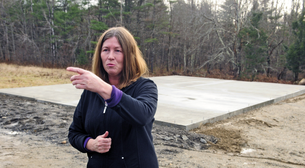 Standing in front of foundation that was recently poured to build a new barn for her cows at her Richmond home, Daria Goggins talks to reporters on Saturday about finding her pair of Herefords shot on Friday afternoon.
