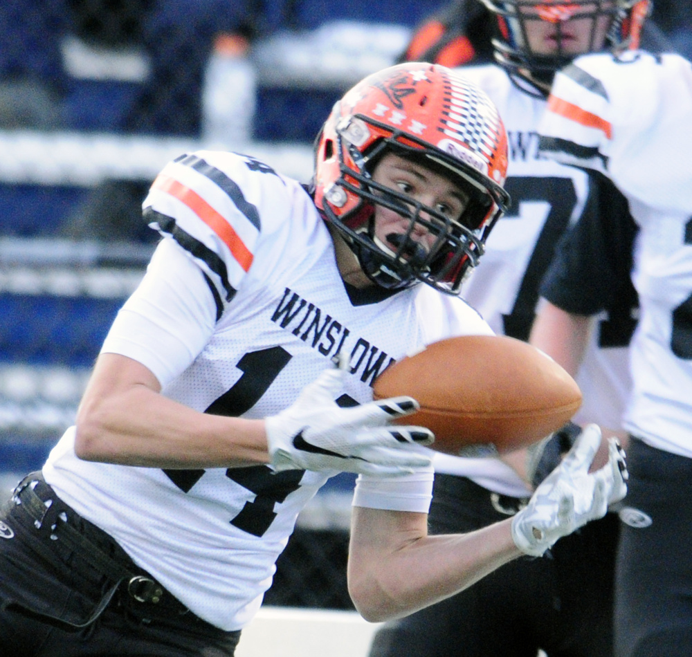 Winslow wide receiver Dylan Hutchinson hauls in a pass during the Class C state championship game against Yarmouth on Saturday at Fitzpatrick Stadium in Portland.