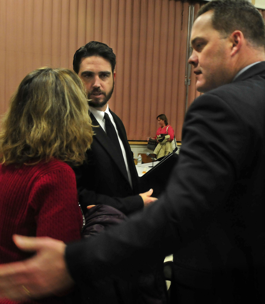 Don Reiter, center, talks to a supporter after the Waterville Board of Education voted to dismiss him on Monday. His attorney, Gregg Frame, is at right.