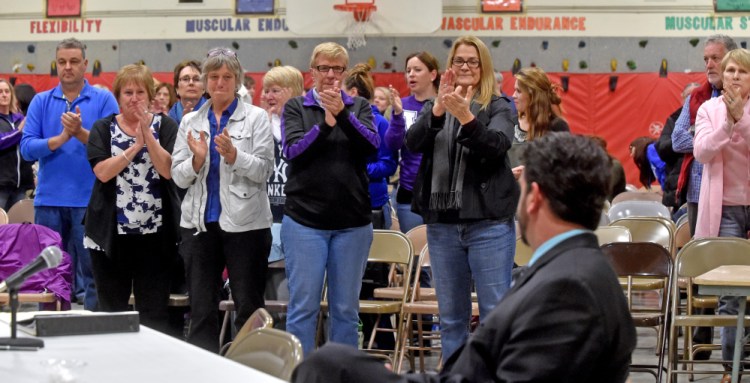 Supporters, including faculty, parents and students, give Don Reiter, sitting at the table far right, a standing ovation during his dismissal hearing before the Waterville Board of Education two weeks ago. Reiter was fired by the board on the hearing’s third night Monday.