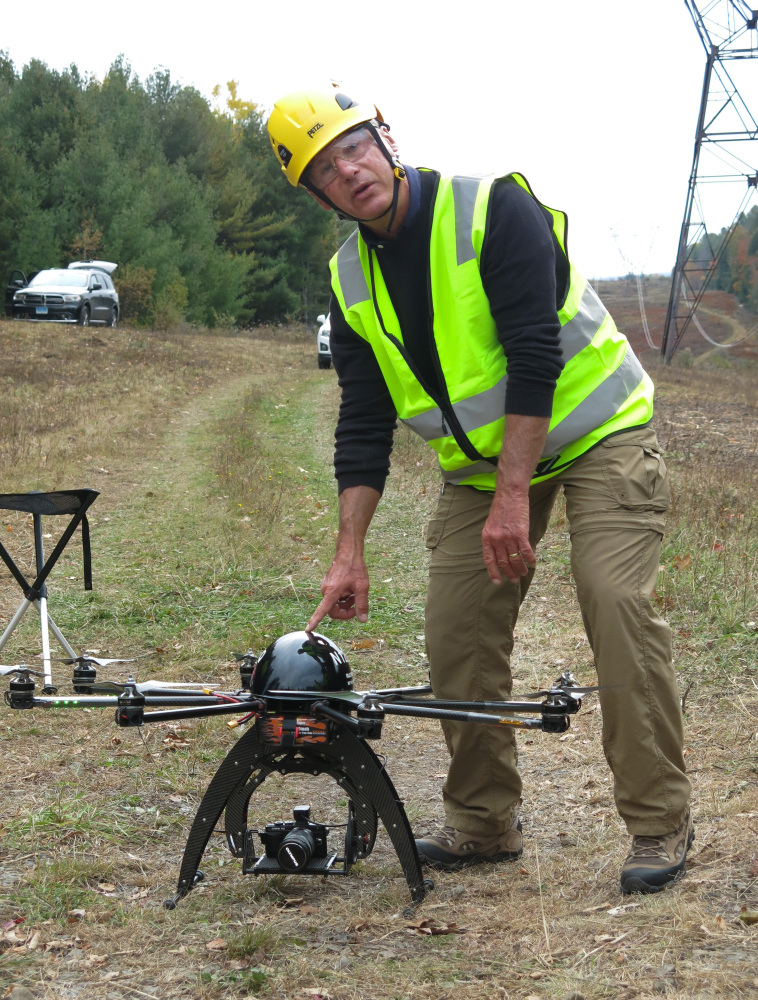 Bernd Lutz, CEO of Boulder, Colorado-based bizUAS Corp., which provides drone services for utilities and other industries, prepares to demonstrate the use of a Cyberhawk octocopter drone for power line inspections at a New York Power Authority site in the Catskills, near Blenheim, New York.