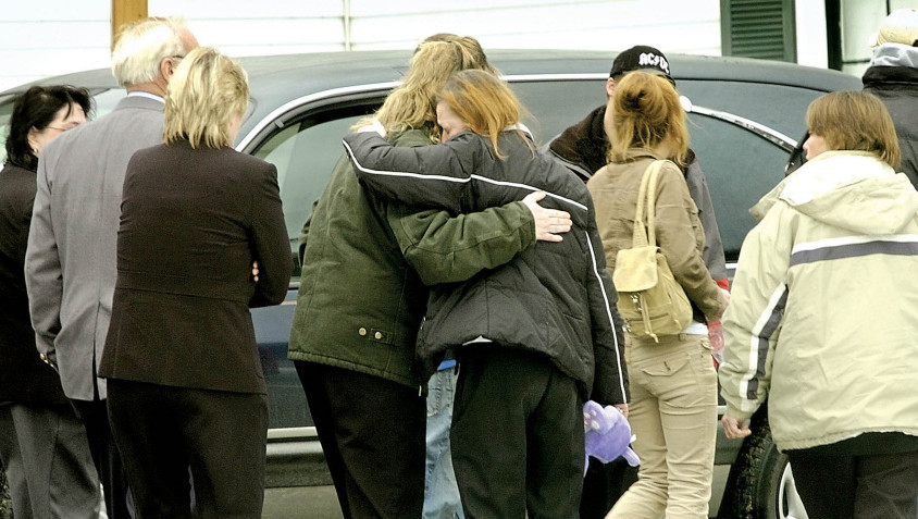 Mourners hug after Amy Drake’s funeral in December 2006 in Skowhegan. Drake’s body was found Nov. 24, 2006, two months after she was last seen. Police have never named a suspect, but say the case remains active.