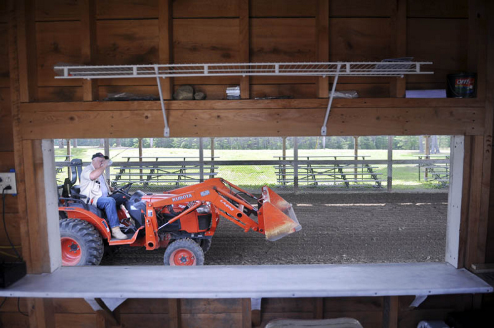 Duddy Brown, a longtime Pittston Fair volunteer, grades the soil in the Greg Baker Pulling Ring at the Pittston Fairgrounds in this July 2013 photo.