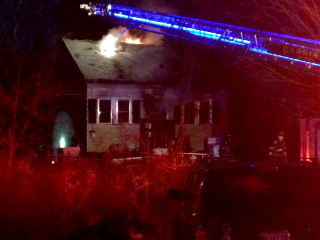 Flames shoot out the roof of a home on Old Brunswick Road in Gardiner Wednesday afternoon.