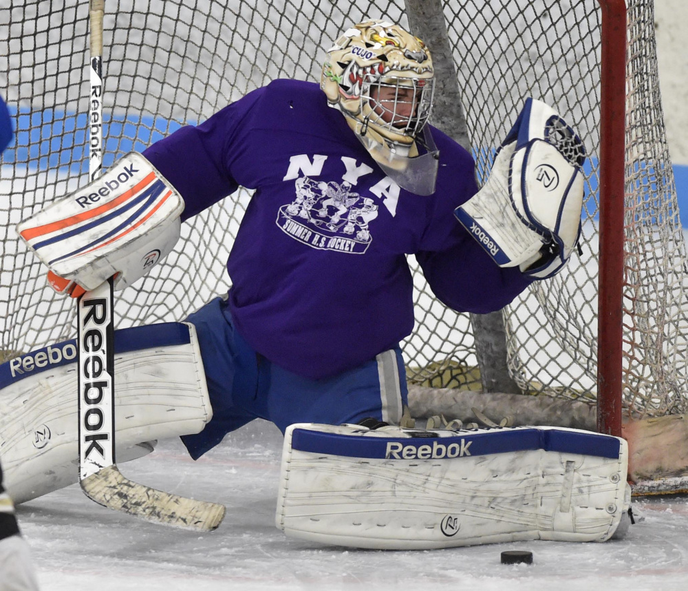 Skowhegan/Lawrence goalie Curtis Martin makes a save during practice last week at Sukee Arena in Winslow.