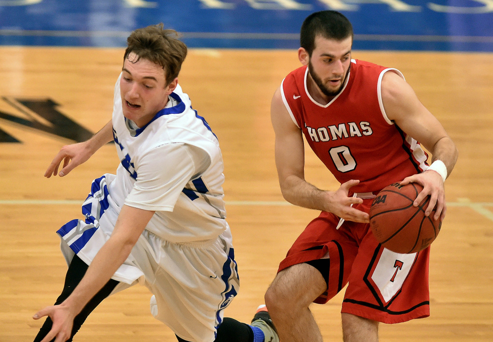 Colby College’s Patrick Stewart, left, tries to steal the ball from Thomas College’s Levi Barnes during a non-conference game Tuesday night in Waterville.